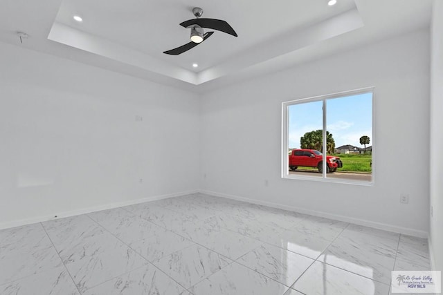 7332 San Andres St, Brownsville, TX 78520 - unfurnished room featuring a raised ceiling, baseboards, ceiling fan, recessed lighting, and light marble finish flooring