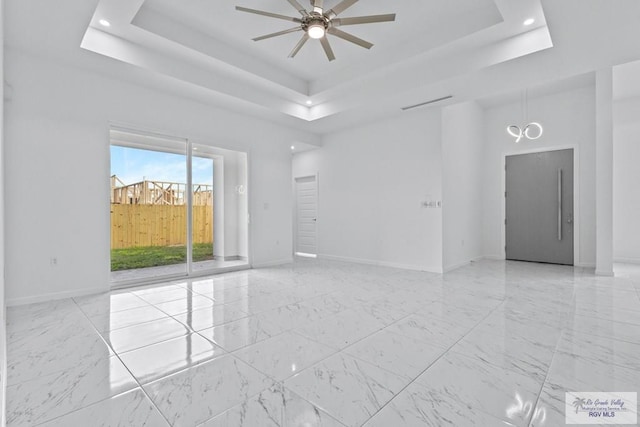 7332 San Andres St, Brownsville, TX 78520 - unfurnished room with ceiling fan, a tray ceiling, baseboards, light marble finish floors, and recessed lighting