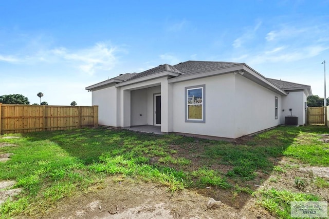 7332 San Andres St, Brownsville, TX 78520 - back of property featuring central AC unit, a shingled roof, and stucco siding