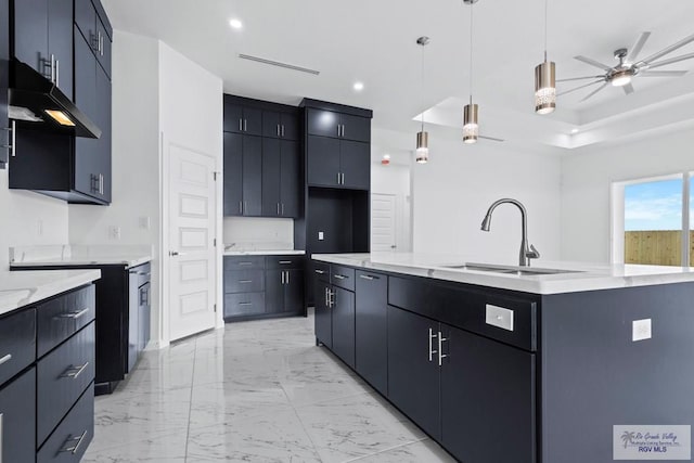 7332 San Andres St, Brownsville, TX 78520 - kitchen with a sink, ceiling fan, a center island with sink, light marble finish flooring, and pendant lighting