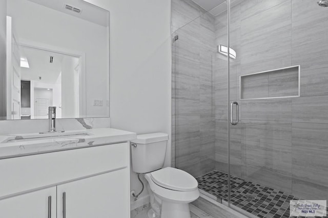 7332 San Andres St, Brownsville, TX 78520 - bathroom with vanity, toilet, and a shower stall