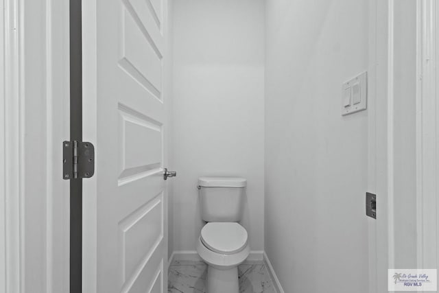7332 San Andres St, Brownsville, TX 78520 - bathroom featuring marble finish floors, toilet, and baseboards