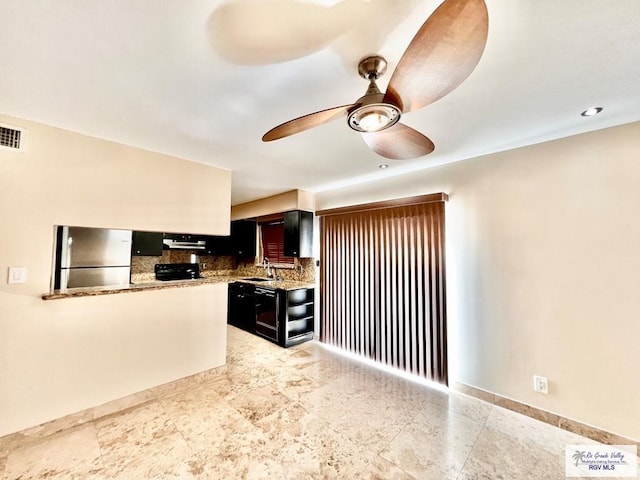 2901 Central Blvd Unit 306, Brownsville, TX 78520 - kitchen with freestanding refrigerator, a sink, tasteful backsplash, a ceiling fan, and dark cabinetry