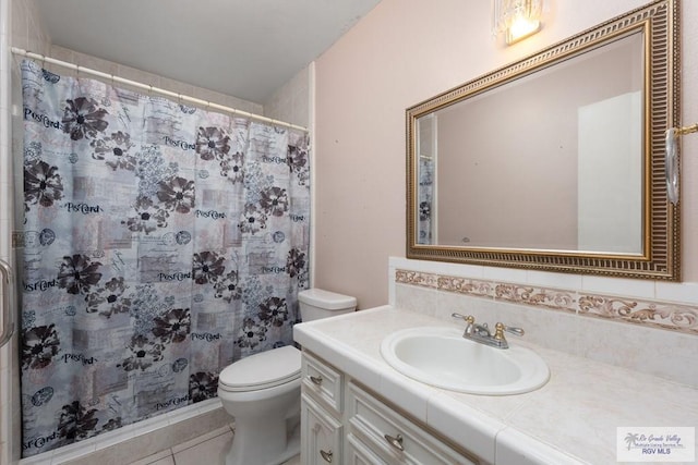 bathroom featuring backsplash, vanity, tile patterned flooring, toilet, and curtained shower