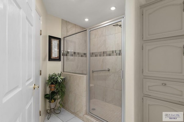 bathroom with tile patterned floors and walk in shower