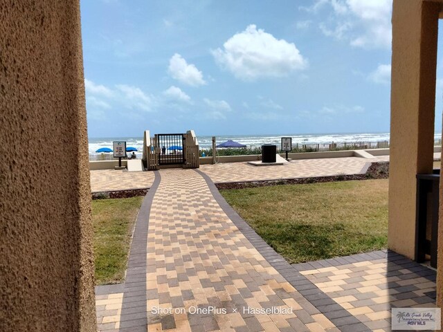 6608 Padre Blvd Unit D-253, South Padre Island, TX 78597 - view of yard featuring a water view, a gate, and fence