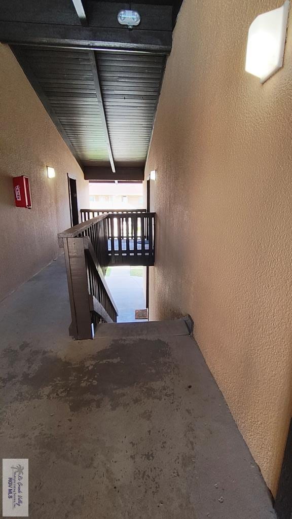6608 Padre Blvd Unit D-253, South Padre Island, TX 78597 - corridor with a textured wall, an upstairs landing, and unfinished concrete floors