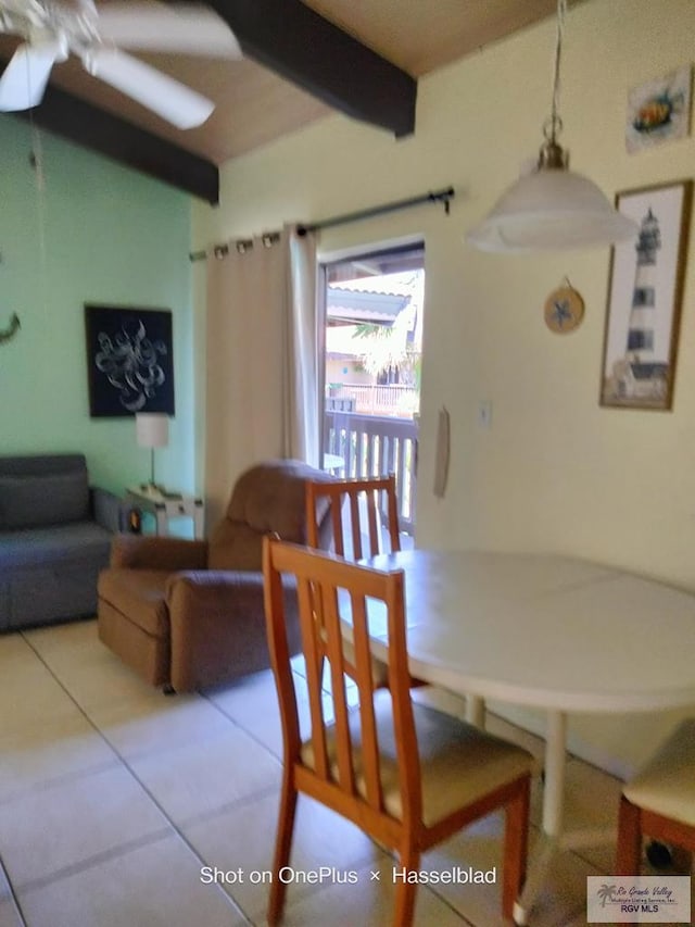 dining room featuring tile patterned flooring and beamed ceiling