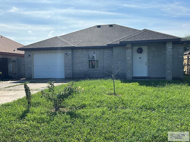 ranch-style house featuring a garage and a front lawn