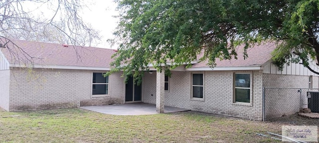 rear view of house featuring a yard and a patio area