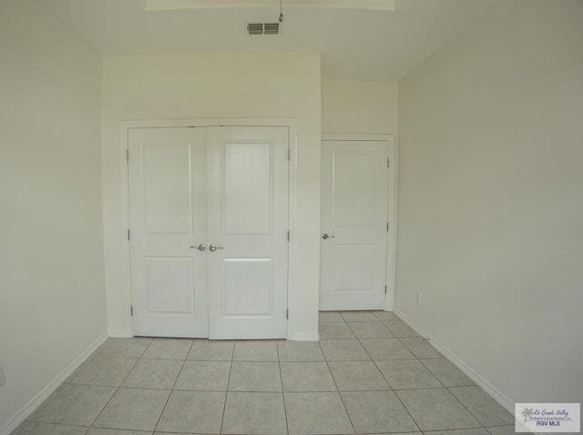 17077 Tangelo Ave, Harlingen, TX 78552 - unfurnished bedroom with light tile patterned floors and a closet