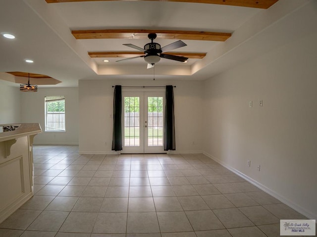 17077 Tangelo Ave, Harlingen, TX 78552 - spare room featuring a ceiling fan, a tray ceiling, recessed lighting, french doors, and light tile patterned floors