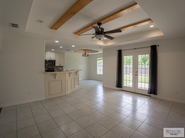 17077 Tangelo Ave, Harlingen, TX 78552 - unfurnished living room with ceiling fan, light tile patterned flooring, recessed lighting, french doors, and a raised ceiling