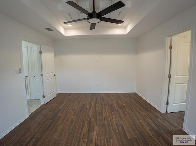 17077 Tangelo Ave, Harlingen, TX 78552 - empty room with a raised ceiling, ceiling fan, and dark wood finished floors