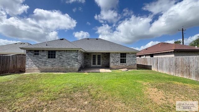 17077 Tangelo Ave, Harlingen, TX 78552 - back of house with french doors, a fenced backyard, and brick siding