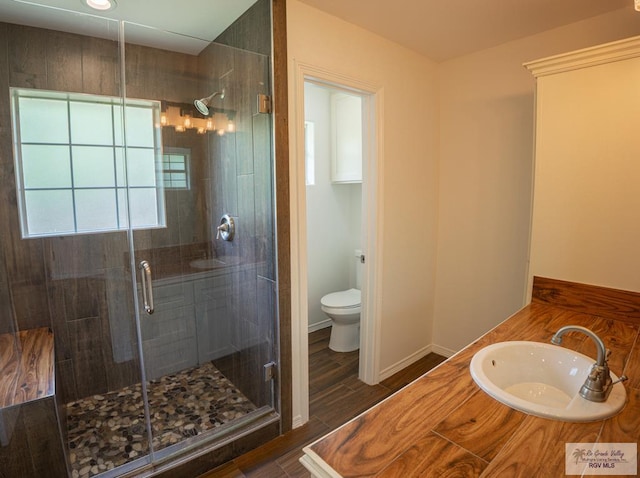 17077 Tangelo Ave, Harlingen, TX 78552 - full bath with a stall shower, wood finish floors, and vanity