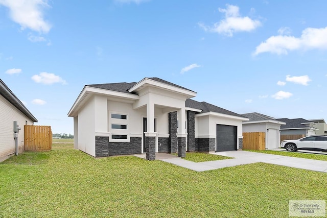 prairie-style house featuring a front lawn and a garage