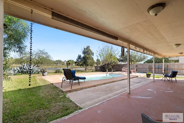 view of patio / terrace featuring a fenced in pool