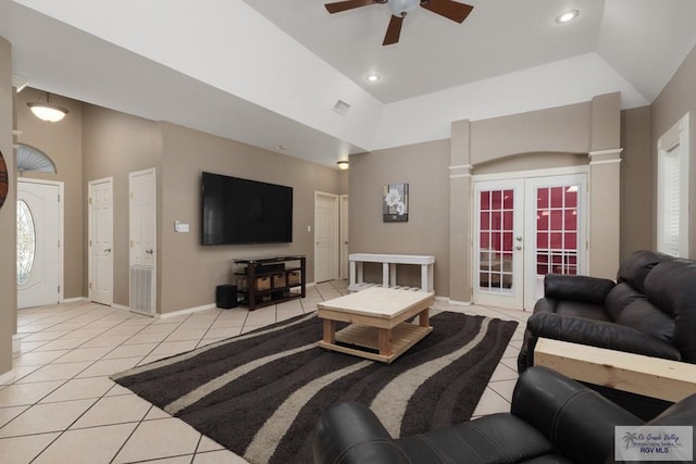 living room featuring light tile patterned floors, baseboards, visible vents, high vaulted ceiling, and french doors