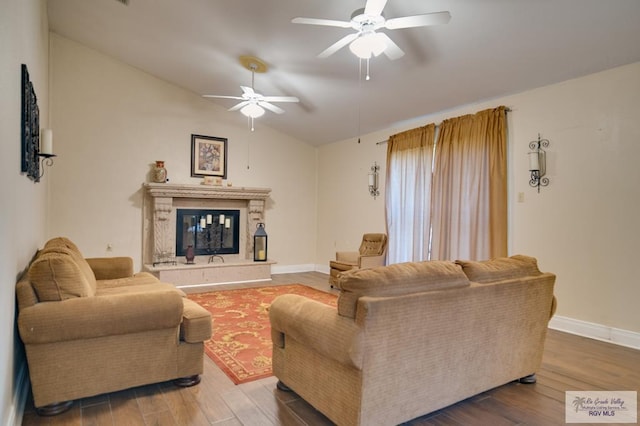 living room featuring hardwood / wood-style flooring, ceiling fan, and lofted ceiling