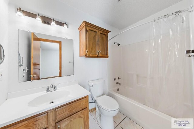 bathroom with tile patterned floors, toilet, a textured ceiling, shower / bath combination with curtain, and vanity