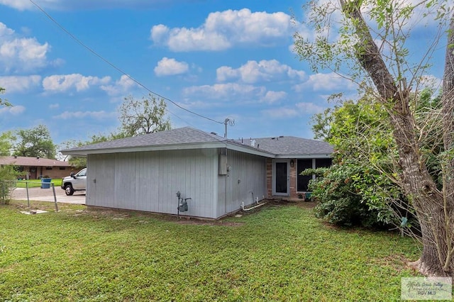 back of property with a lawn