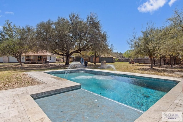 view of pool with a fenced in pool, fence, an outdoor structure, and a patio area