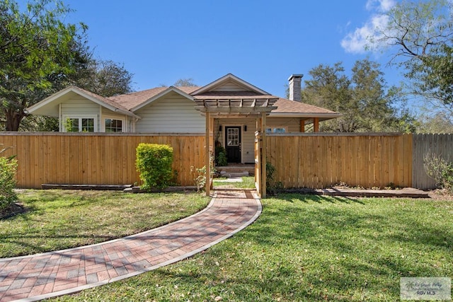 view of front of home featuring a chimney, a front lawn, and fence