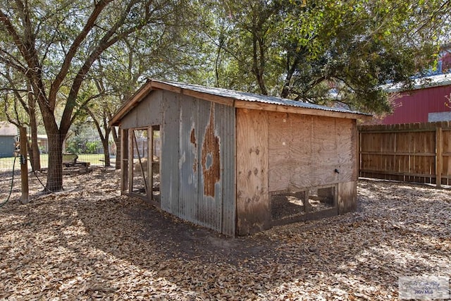 view of outdoor structure with an outbuilding and fence