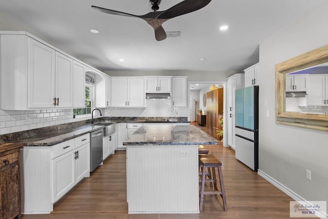 kitchen featuring under cabinet range hood, white cabinetry, fridge, a ceiling fan, and stainless steel dishwasher