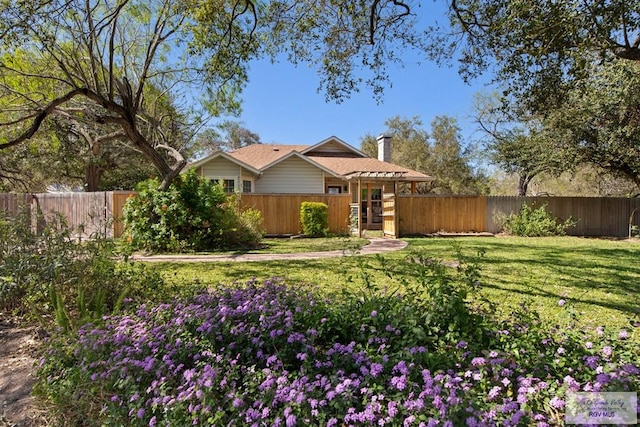 exterior space with a front yard and a fenced backyard