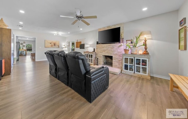 living room featuring recessed lighting, a ceiling fan, light wood-type flooring, and baseboards