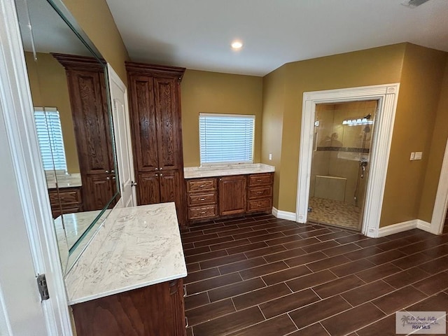 bathroom featuring vanity and an enclosed shower