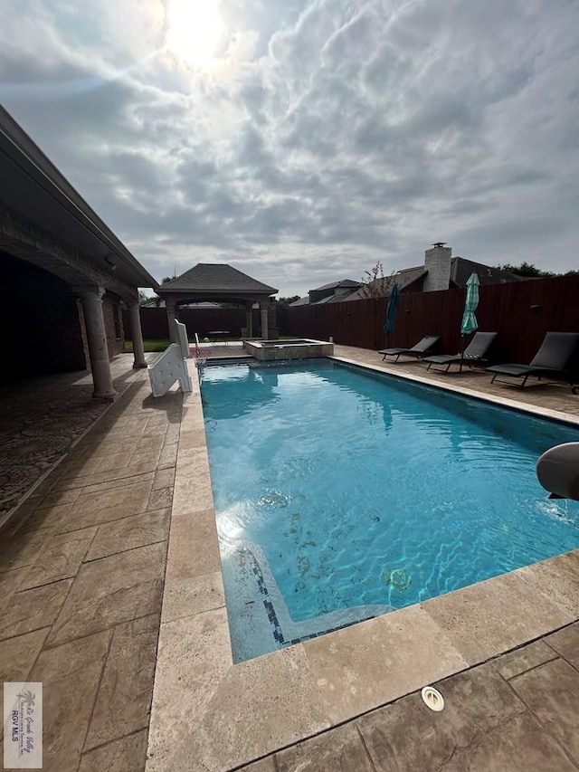 view of pool featuring a gazebo and a patio area