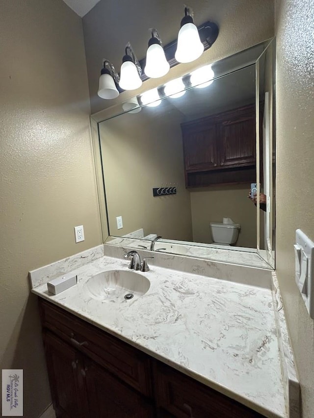 bathroom with vanity and toilet