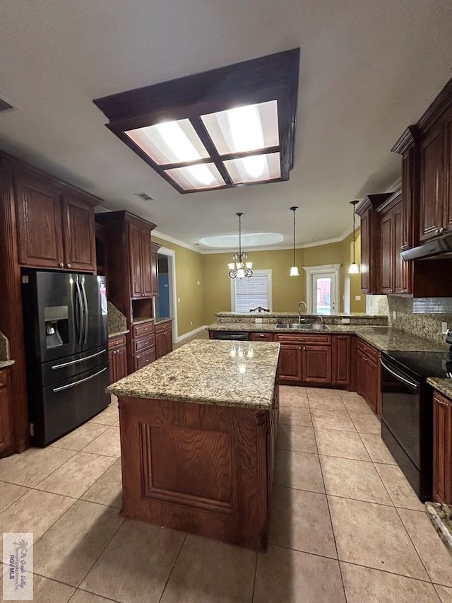 kitchen featuring pendant lighting, light tile patterned flooring, black appliances, and a kitchen island