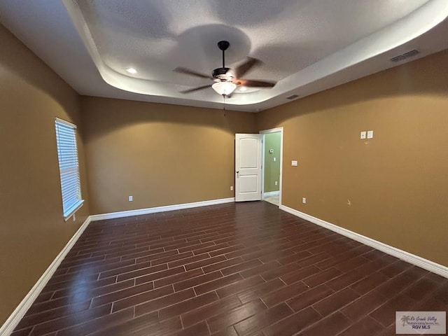 unfurnished room with a tray ceiling and ceiling fan