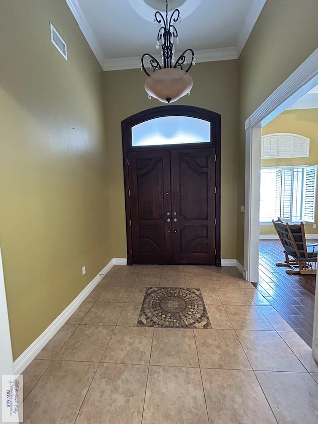 tiled foyer with ornamental molding