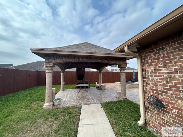 view of patio / terrace featuring a gazebo and a fireplace