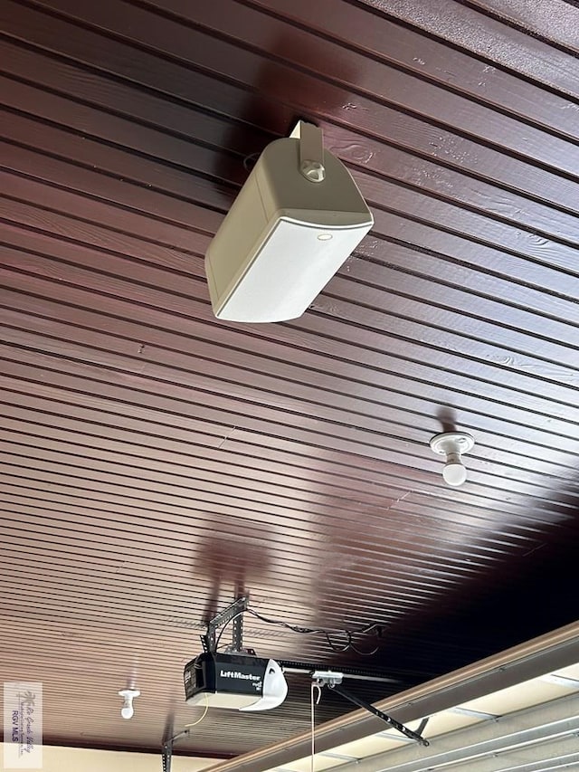 details with a garage door opener and wooden ceiling