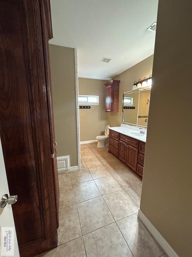 bathroom featuring tile patterned flooring, vanity, and toilet