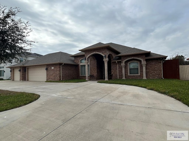 view of front of property with a garage and a front yard