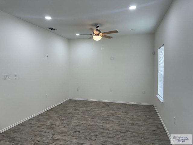 empty room with ceiling fan and dark wood-type flooring