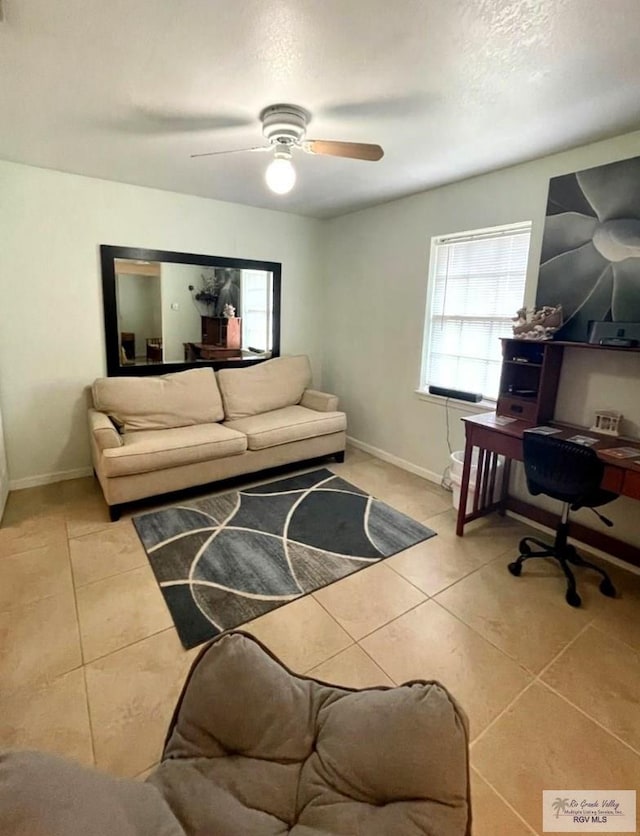 living room featuring ceiling fan and light tile patterned floors