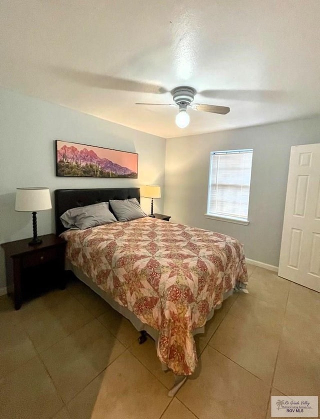 tiled bedroom featuring ceiling fan