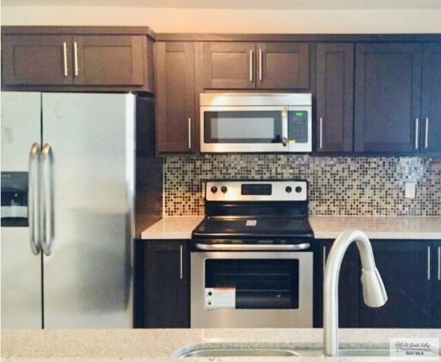 kitchen featuring backsplash, sink, and stainless steel appliances