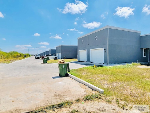 view of side of home with a garage and a yard