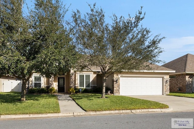 obstructed view of property with a garage and a front lawn