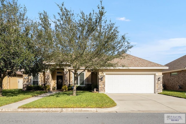 obstructed view of property featuring a garage and a front lawn