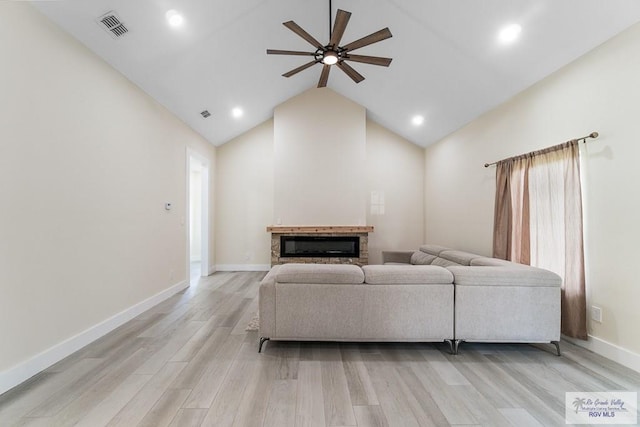 living room featuring ceiling fan, light hardwood / wood-style flooring, and high vaulted ceiling